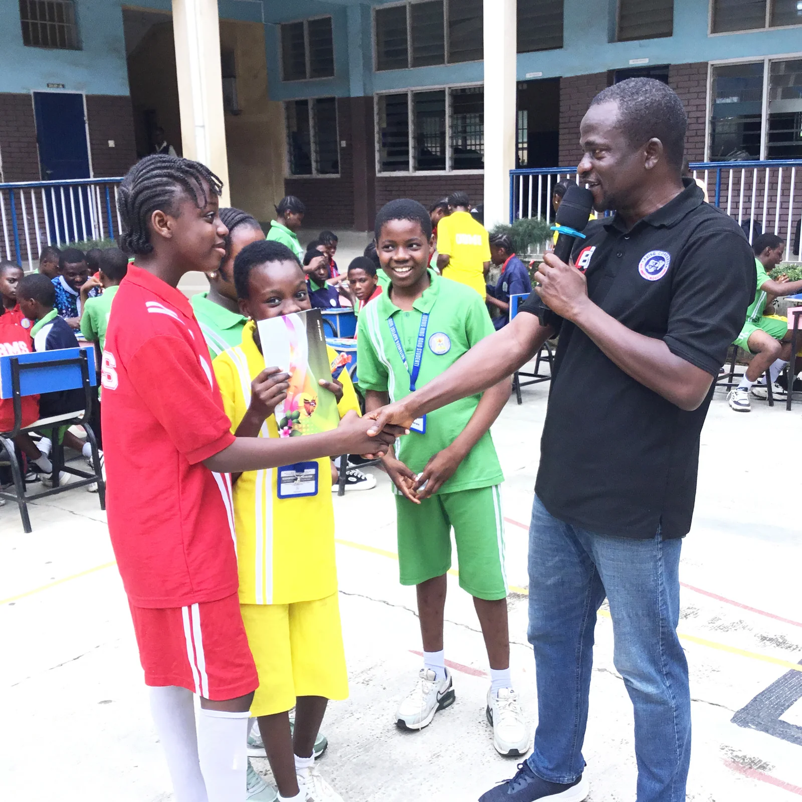 Game winners at Oritamefa Model School Ibadan receiving handshake.JPG